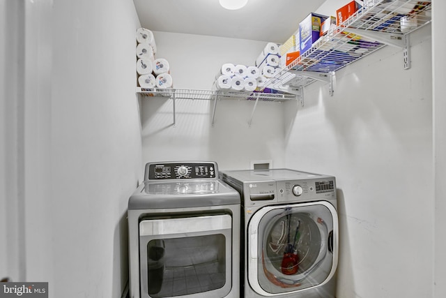 clothes washing area with laundry area and washer and clothes dryer