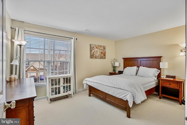 carpeted bedroom featuring visible vents and baseboards