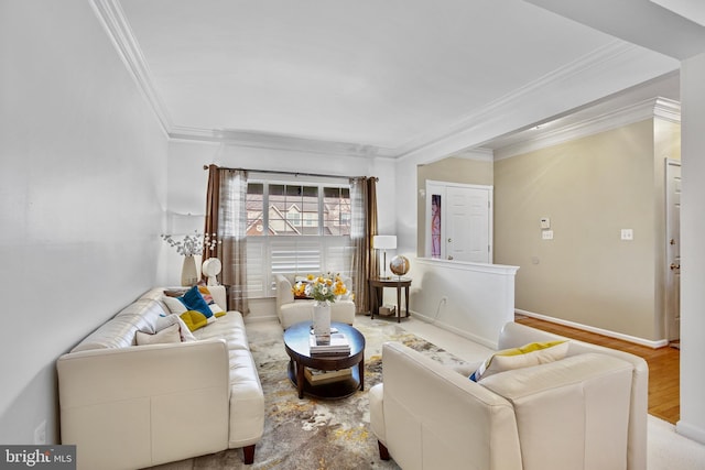 living area with ornamental molding, baseboards, and wood finished floors