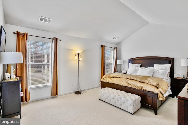 bedroom with vaulted ceiling, carpet flooring, visible vents, and baseboards