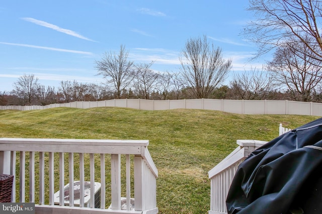 view of yard with central AC and fence