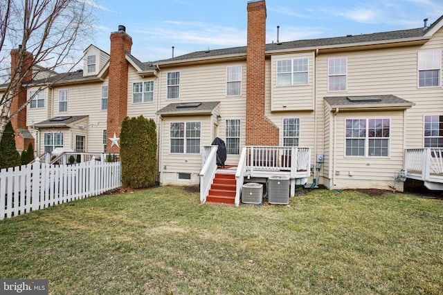 rear view of property with central AC, a lawn, fence private yard, and a wooden deck