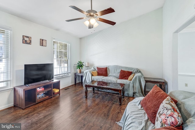 living room featuring visible vents, baseboards, a ceiling fan, and wood finished floors