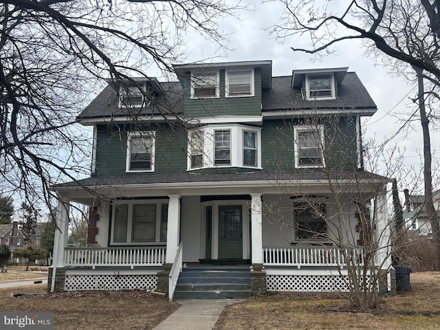 american foursquare style home with a porch