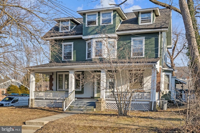 view of front of property with a porch and roof with shingles