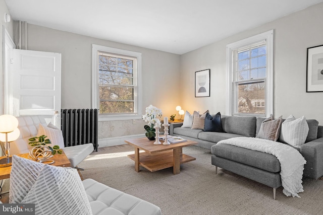 living room featuring radiator and baseboards