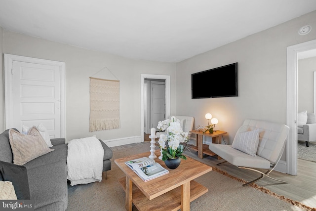 living room featuring wood finished floors and baseboards