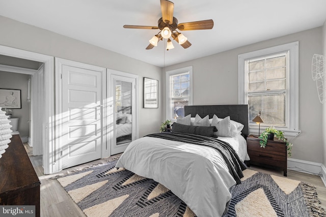 bedroom featuring ceiling fan, access to outside, light wood-type flooring, and baseboards