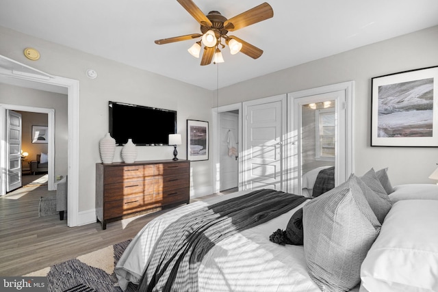 bedroom featuring ceiling fan, wood finished floors, and baseboards