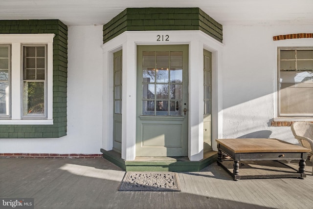 doorway to property featuring covered porch