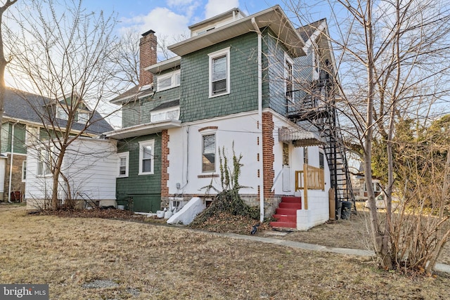 view of front of house featuring a chimney