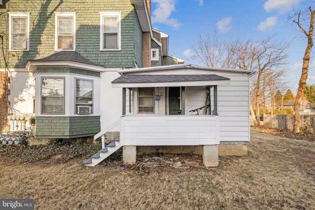 view of front of property featuring covered porch and a shingled roof