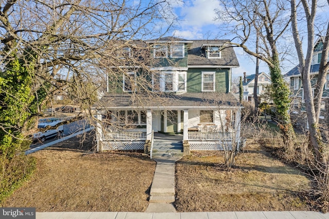 view of front of property featuring covered porch and roof with shingles