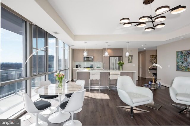 dining room with baseboards, visible vents, dark wood-style flooring, a notable chandelier, and recessed lighting