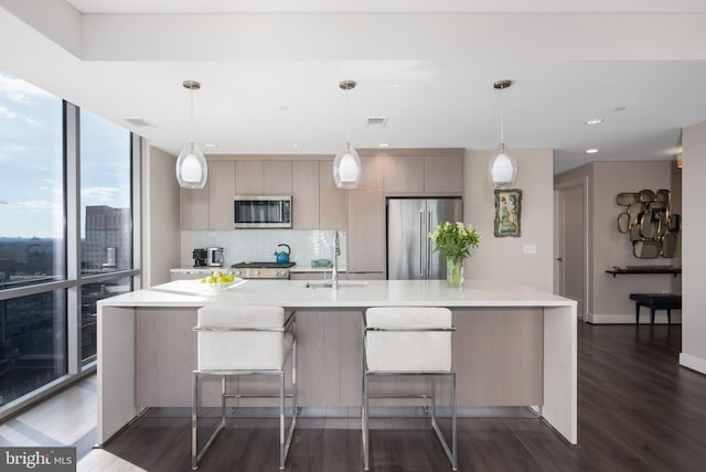 kitchen with stainless steel appliances, visible vents, light countertops, backsplash, and a sink