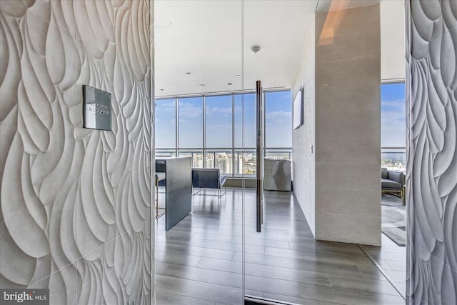 interior space featuring wood finished floors and floor to ceiling windows