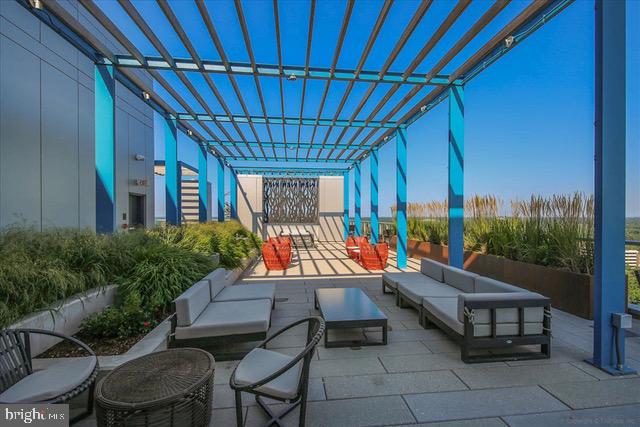 view of patio featuring an outdoor living space and a pergola