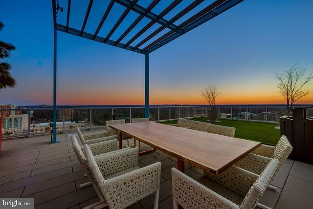 wooden deck featuring outdoor dining area and a patio