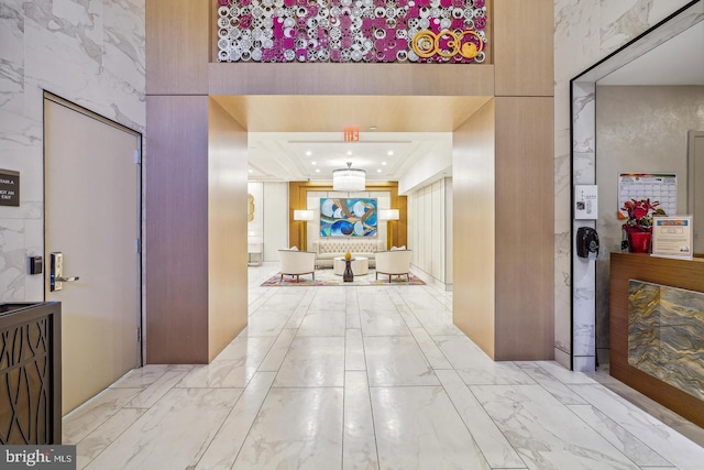 hallway featuring marble finish floor