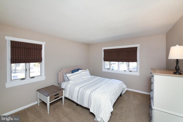 bedroom with baseboards, multiple windows, and carpet flooring