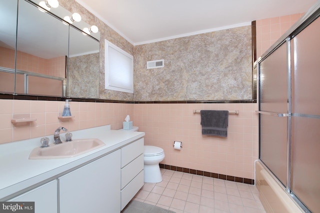 bathroom with visible vents, toilet, tile patterned flooring, crown molding, and vanity