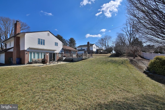 view of yard featuring a garage, fence, and a patio