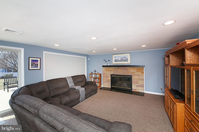 living room featuring recessed lighting, visible vents, baseboards, and a stone fireplace