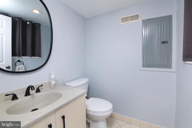 bathroom with electric panel, visible vents, toilet, tile patterned flooring, and vanity