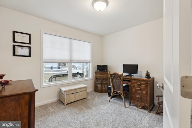 carpeted home office with baseboards