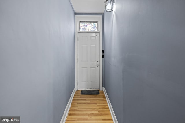 entryway with light wood-type flooring and baseboards