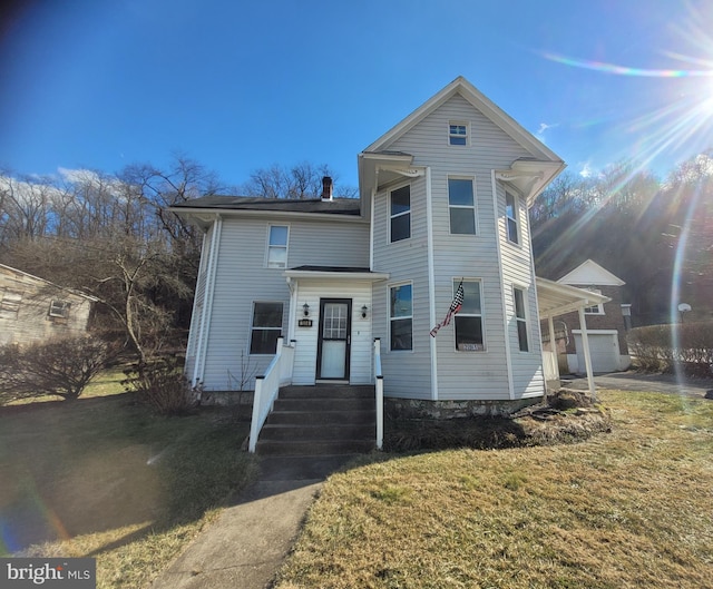 view of front of home featuring a garage and a front lawn