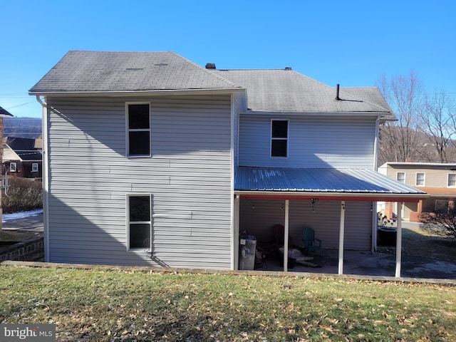 back of house with a yard and a patio