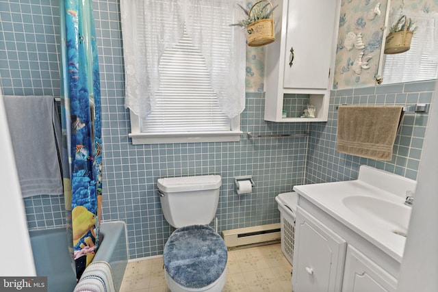 bathroom with toilet, shower / bath combo, a baseboard heating unit, tile walls, and vanity