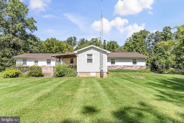 rear view of house with a yard