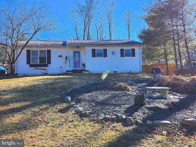 view of front of property featuring crawl space, fence, and metal roof