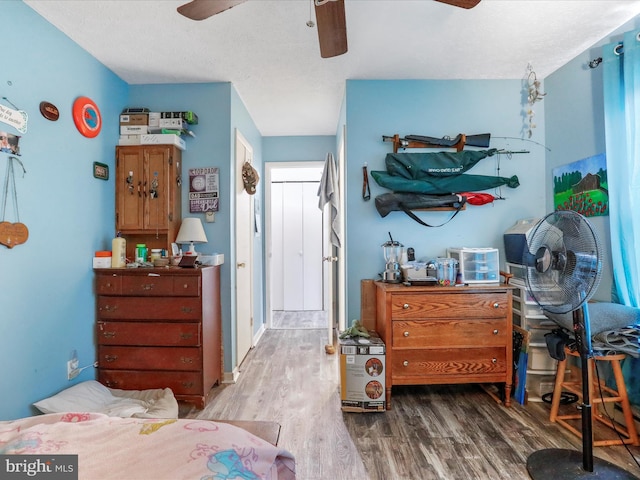 bedroom with a ceiling fan and wood finished floors