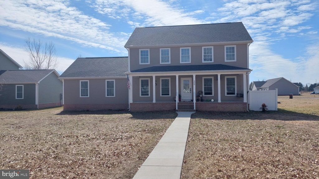 view of front of home featuring covered porch and a front yard