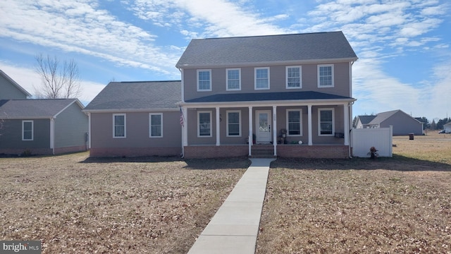 view of front of home featuring covered porch and a front yard