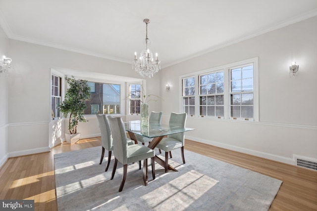 7310 Alaska Ave NW, Washington, DC 20012 - dining space with plenty of natural light, baseboards, visible vents, wood finished floors, and a chandelier