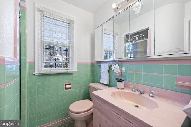 7310 Alaska Ave NW, Washington, DC 20012 - full bathroom featuring a wainscoted wall, tile walls, toilet, and vanity