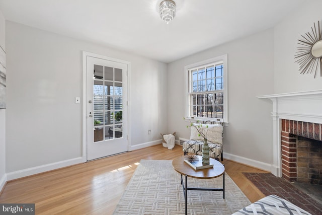 7310 Alaska Ave NW, Washington, DC 20012 - living area featuring a fireplace, wood finished floors, a wealth of natural light, and baseboards
