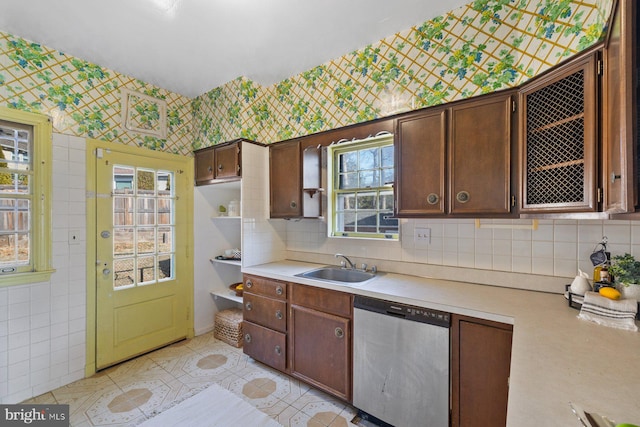 7310 Alaska Ave NW, Washington, DC 20012 - kitchen with light countertops, a sink, dark brown cabinets, dishwasher, and wallpapered walls