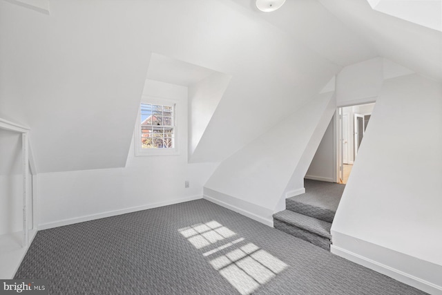 7310 Alaska Ave NW, Washington, DC 20012 - additional living space with lofted ceiling, baseboards, and dark colored carpet