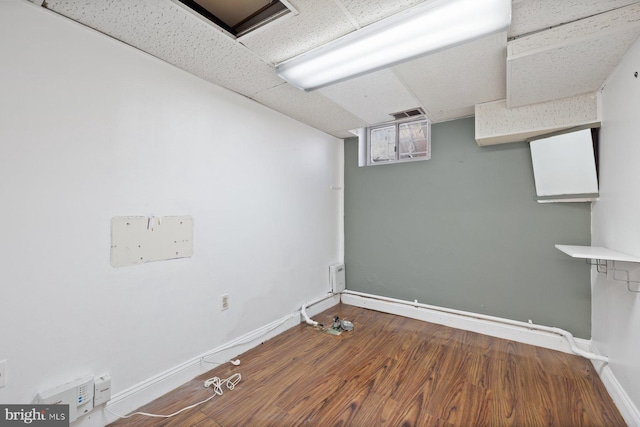 7310 Alaska Ave NW, Washington, DC 20012 - unfurnished room with a paneled ceiling, visible vents, baseboards, and wood finished floors