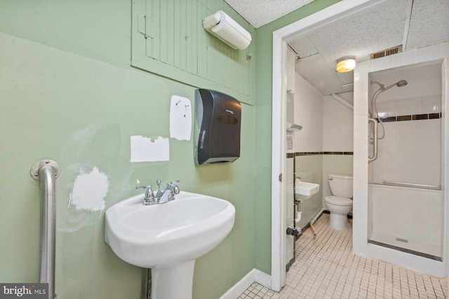 7310 Alaska Ave NW, Washington, DC 20012 - full bathroom with tile walls, toilet, a stall shower, a sink, and tile patterned floors