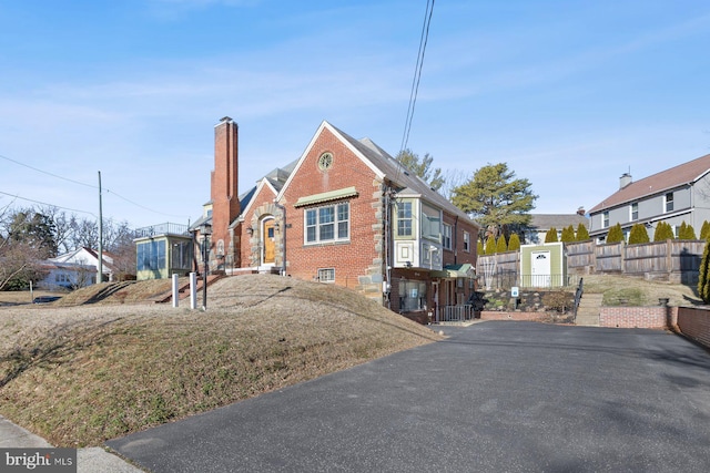 7310 Alaska Ave NW, Washington, DC 20012 - view of front of home featuring brick siding, a chimney, fence, and a residential view