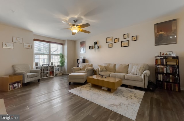 living room with dark wood finished floors and a ceiling fan