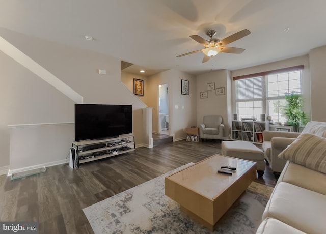 living area with dark wood finished floors, baseboards, and ceiling fan