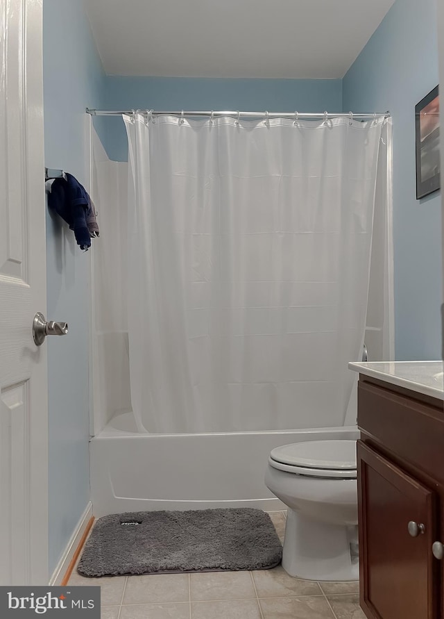 bathroom with vanity, tile patterned flooring, toilet, and shower / tub combo with curtain