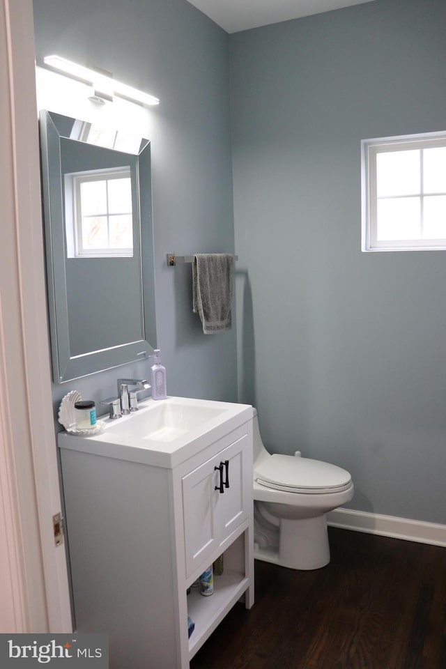 210 Potomac Ridge Dr, Fort Washington, MD 20744 - half bath featuring vanity, toilet, plenty of natural light, and wood finished floors